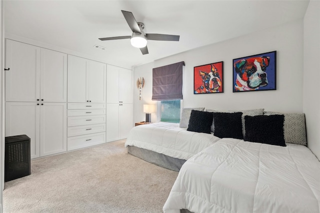 carpeted bedroom with ceiling fan and a closet