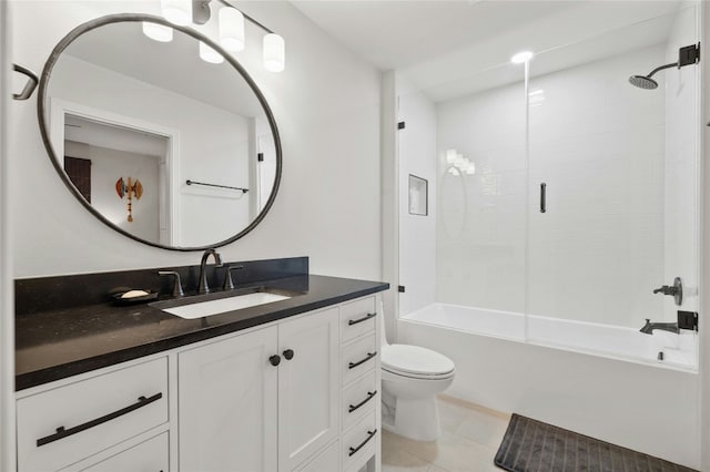 full bathroom featuring tile patterned floors, vanity, toilet, and tiled shower / bath combo