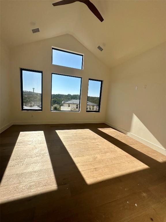 additional living space with high vaulted ceiling, dark wood-type flooring, and ceiling fan