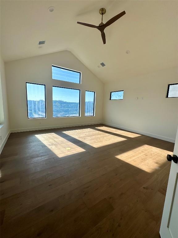 interior space with high vaulted ceiling, dark hardwood / wood-style floors, and ceiling fan