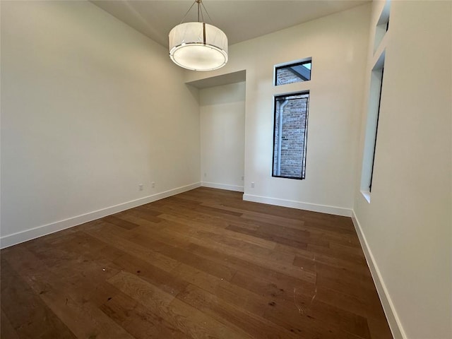 unfurnished room with dark hardwood / wood-style floors