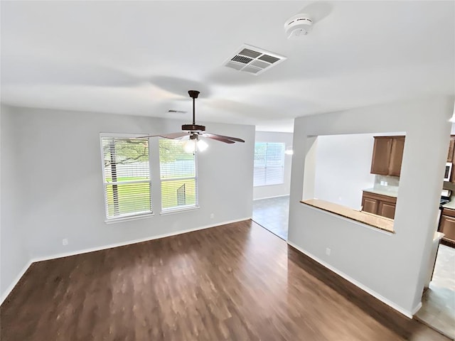 interior space with ceiling fan and dark hardwood / wood-style floors