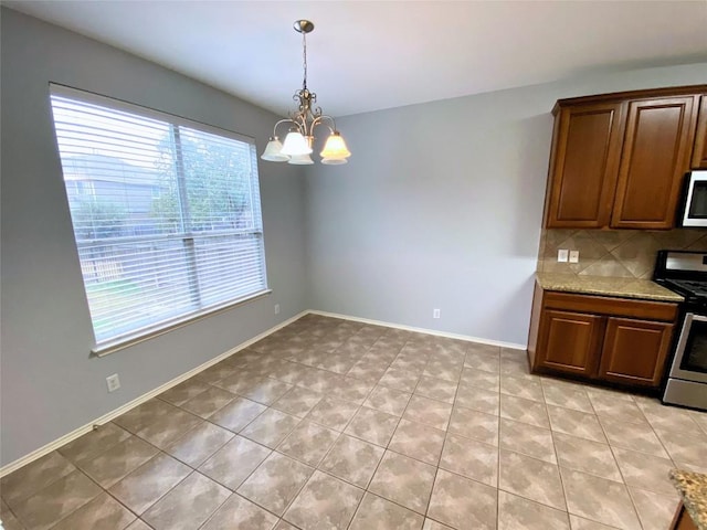 unfurnished dining area featuring an inviting chandelier and light tile patterned floors