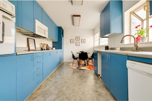 kitchen featuring sink, white appliances, and blue cabinets