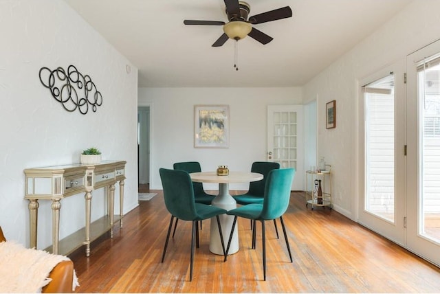 dining space featuring ceiling fan and hardwood / wood-style floors