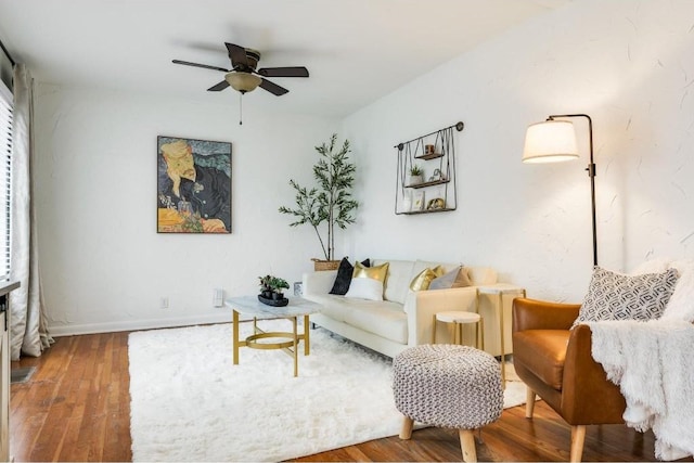 living room featuring hardwood / wood-style floors and ceiling fan