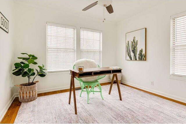 1405 Brentwood St, Austin, TX 78757 - home office featuring wood finished floors, ceiling fan, and baseboards
