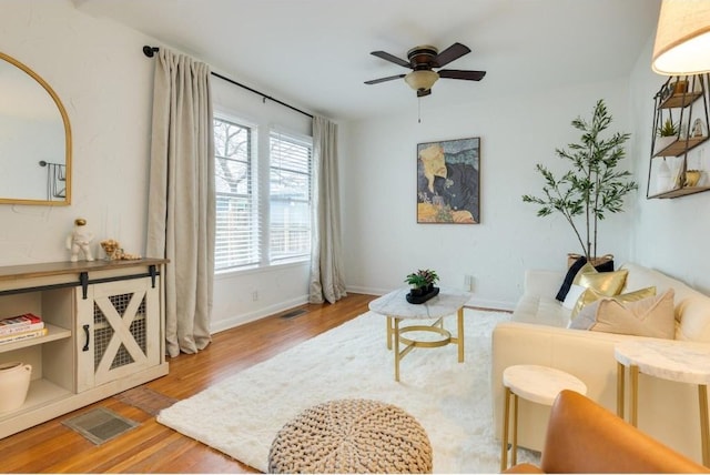 living room featuring ceiling fan and light wood-type flooring