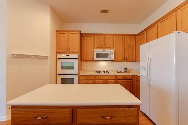 kitchen featuring a center island and white appliances