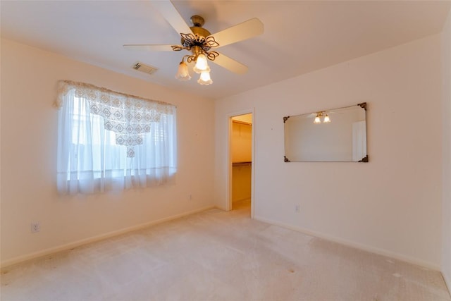 unfurnished room featuring ceiling fan and carpet flooring