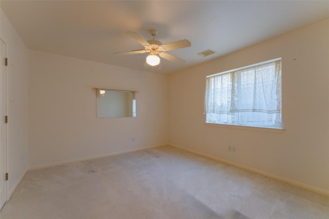 spare room with light carpet and ceiling fan