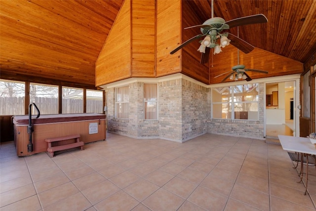 sunroom / solarium featuring wood ceiling, ceiling fan, and lofted ceiling