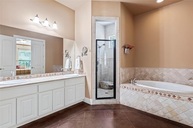 bathroom with tile patterned flooring, vanity, and independent shower and bath