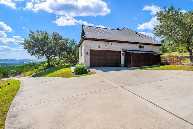 view of property exterior featuring a garage and a lawn