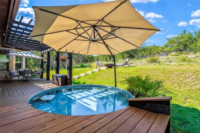 view of swimming pool featuring a wooden deck and a lawn