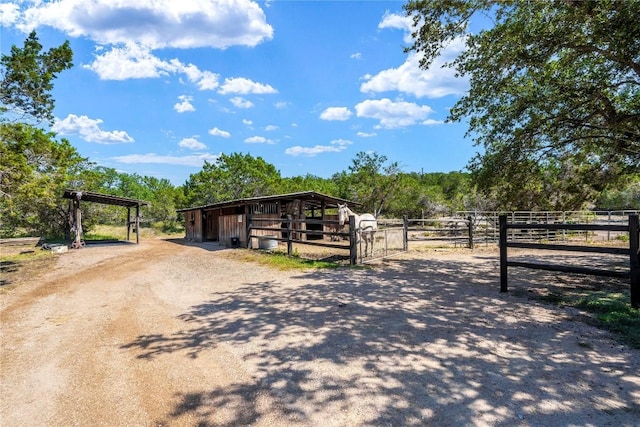 view of stable featuring a rural view