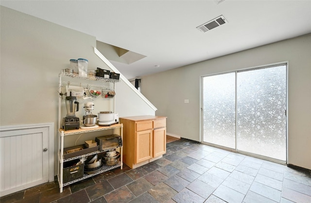 bar featuring light brown cabinetry