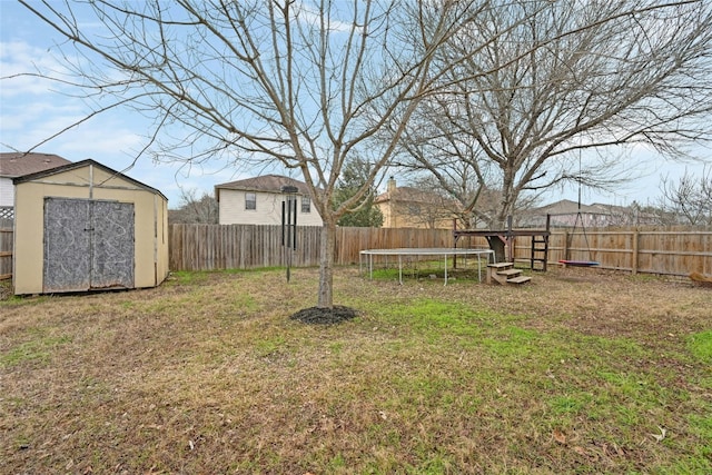 view of yard featuring a shed and a trampoline