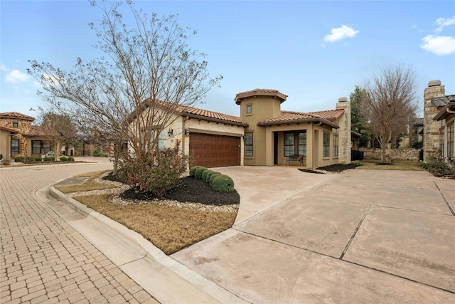 204 Delfino Cir, Lakeway, TX 78734 - mediterranean / spanish-style home with an attached garage, driveway, a tile roof, and stucco siding