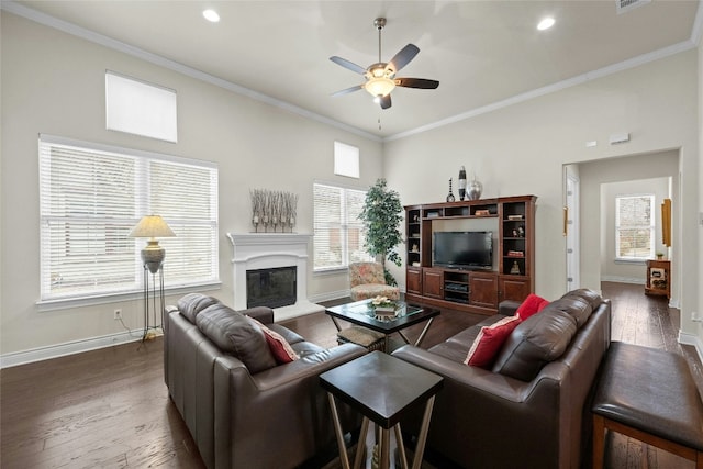 living room featuring dark wood-type flooring, ornamental molding, and ceiling fan