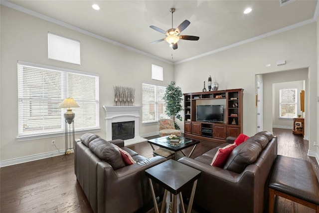 204 Delfino Cir, Lakeway, TX 78734 - living room with ceiling fan, dark wood-style flooring, a glass covered fireplace, ornamental molding, and recessed lighting