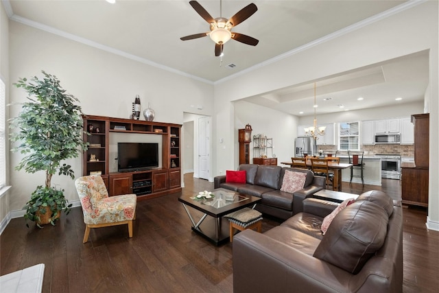 living room with ornamental molding, dark hardwood / wood-style floors, and ceiling fan with notable chandelier