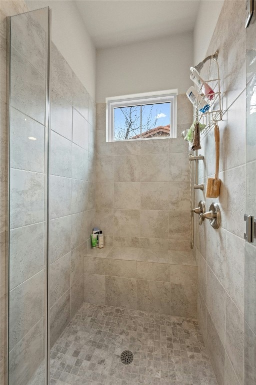 bathroom with a tile shower