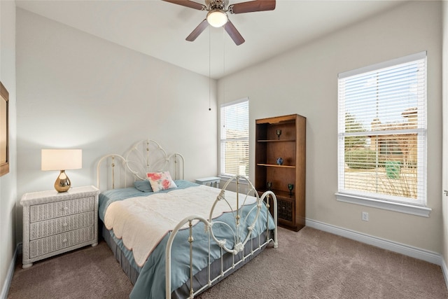 carpeted bedroom with ceiling fan and multiple windows