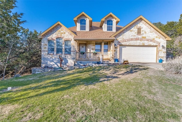 view of front of property featuring a garage, covered porch, and a front yard