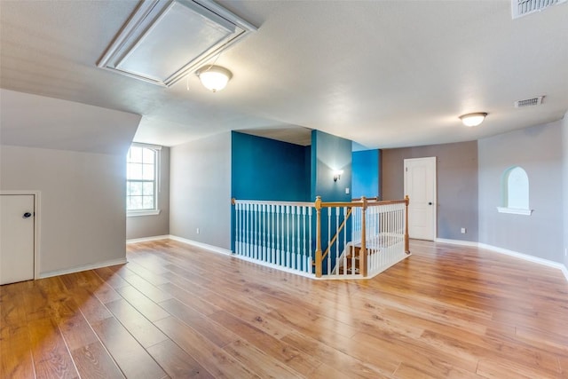 additional living space featuring light wood-type flooring