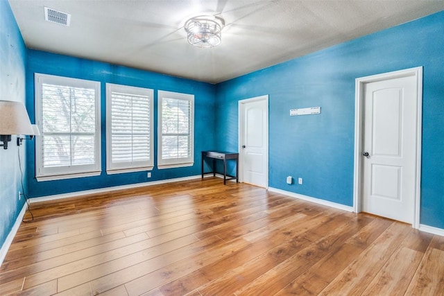 unfurnished room featuring wood-type flooring