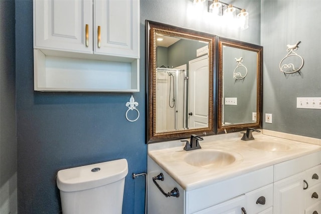 bathroom with a shower with door, vanity, and toilet