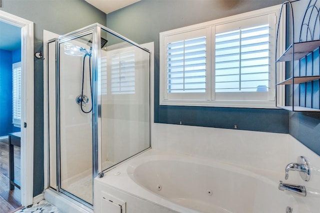 bathroom featuring separate shower and tub