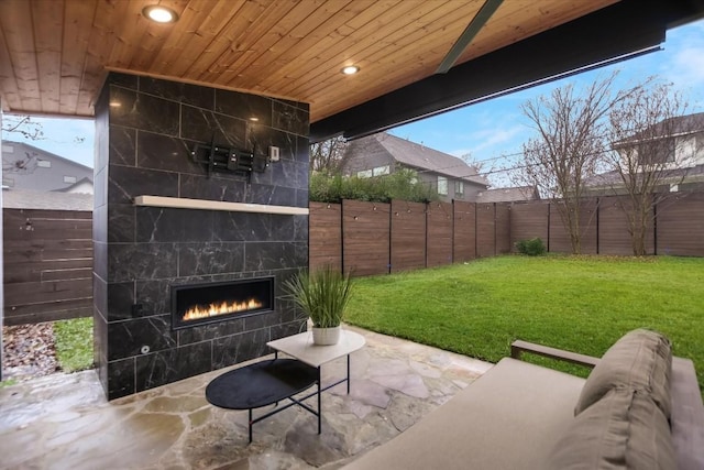 view of patio with an outdoor living space with a fireplace