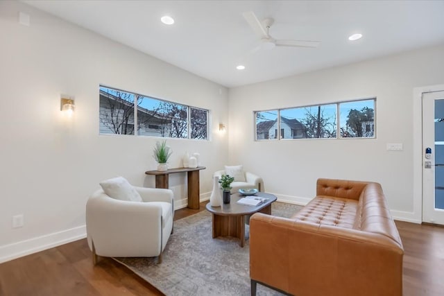 living area with hardwood / wood-style flooring and ceiling fan