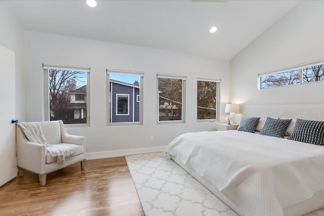 bedroom with lofted ceiling and hardwood / wood-style flooring