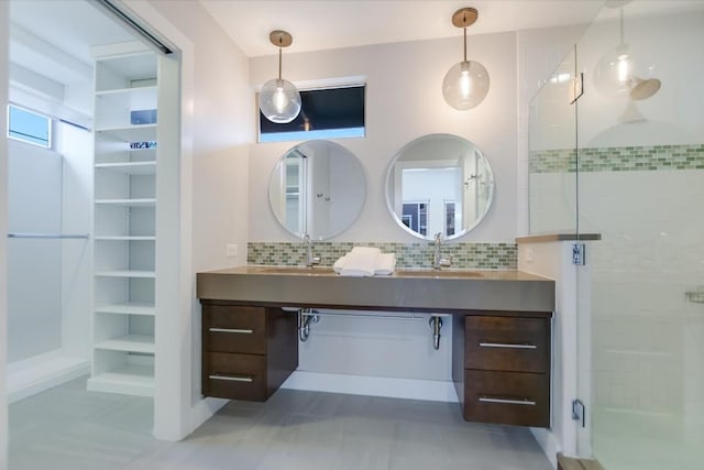 bathroom with an enclosed shower, vanity, and tasteful backsplash