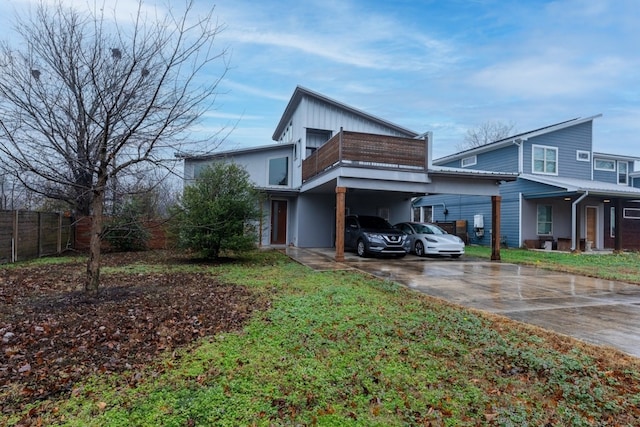 view of property exterior featuring a carport and a balcony