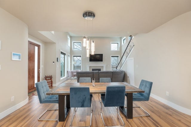 3301 Rockhurst Ln, Austin, TX 78723 - dining space featuring a fireplace, healthy amount of natural light, and light wood-style floors