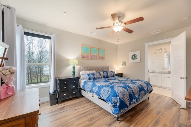 3301 Rockhurst Ln, Austin, TX 78723 - bedroom with light wood-style floors, ensuite bath, and ceiling fan