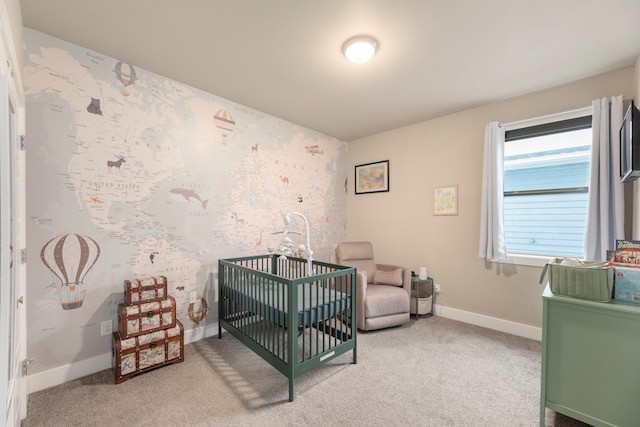 bedroom featuring a nursery area and light carpet