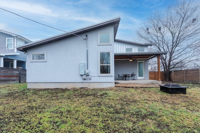 3301 Rockhurst Ln, Austin, TX 78723 - rear view of house featuring a fire pit, a ceiling fan, a patio area, a fenced backyard, and stucco siding