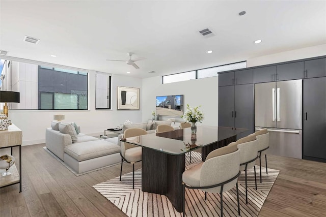 dining room featuring light hardwood / wood-style floors and ceiling fan