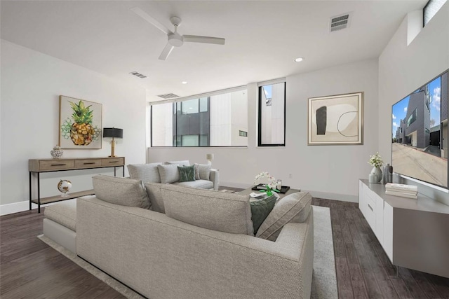 living room with dark hardwood / wood-style flooring and ceiling fan