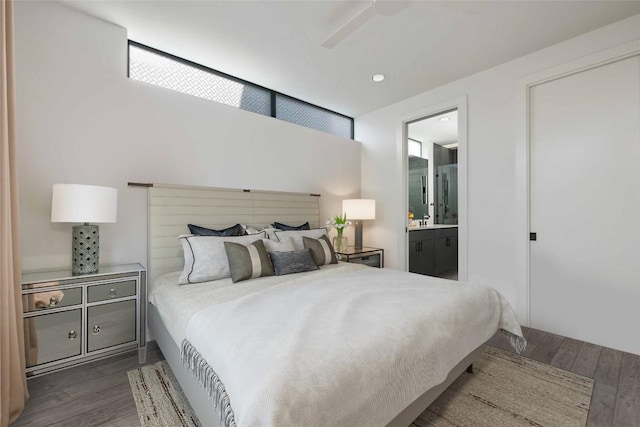 bedroom with ceiling fan, dark hardwood / wood-style floors, sink, and ensuite bath