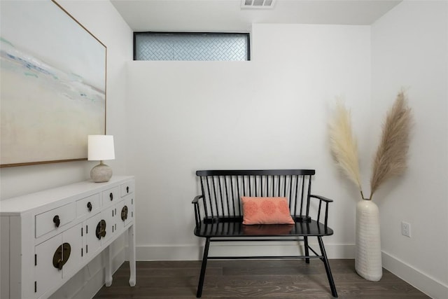 sitting room with dark wood-type flooring