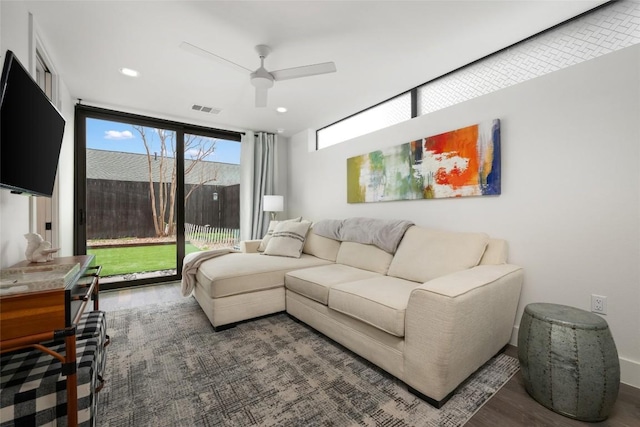 living room featuring hardwood / wood-style flooring and ceiling fan