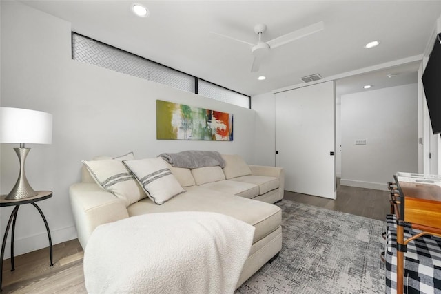 living room featuring hardwood / wood-style flooring and ceiling fan