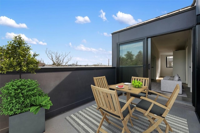 view of patio featuring outdoor dining space and a balcony