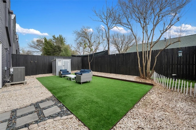 view of yard featuring outdoor lounge area, central AC unit, and a storage unit